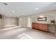 Spacious finished basement with neutral carpeting, recessed lighting, and a built-in bar area at 245 Main St, Broomfield, CO 80020