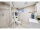 Modern bathroom featuring tiled shower with glass door and updated vanity at 245 Main St, Broomfield, CO 80020