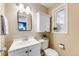 Cozy bathroom features a white vanity, built in cabinet, and a window for natural lighting at 245 Main St, Broomfield, CO 80020