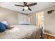 Bedroom with hardwood floors, ceiling fan, and view into en suite bathroom with white vanity at 245 Main St, Broomfield, CO 80020