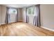 Bright bedroom with hardwood floors and natural light streaming through large windows with gray curtains at 245 Main St, Broomfield, CO 80020
