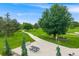 Serene community park featuring walking paths, lush green spaces, picnic tables, and mature trees at 245 Main St, Broomfield, CO 80020