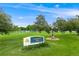 Well-maintained community park entrance sign with lush greenery, playground, and tennis court views at 245 Main St, Broomfield, CO 80020