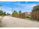 Long driveway leading to a fenced backyard with storage shed and lush green lawn at 245 Main St, Broomfield, CO 80020