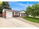 Inviting home with an attached garage, lush lawn and mature tree in a quiet neighborhood at 245 Main St, Broomfield, CO 80020