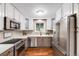 Well-lit kitchen featuring stainless steel appliances, white cabinets, and ample counter space at 245 Main St, Broomfield, CO 80020