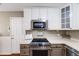 Modern kitchen with stainless appliances and white cabinets at 245 Main St, Broomfield, CO 80020