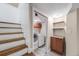 Convenient laundry room featuring a washer, dryer, storage, and stairs leading to the basement at 245 Main St, Broomfield, CO 80020