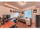 Bright bedroom with a large window, desk with computer, and comfortable bed, offering a functional and relaxing space at 7945 York St # 2, Denver, CO 80229