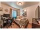 Cozy bedroom with neutral decor, a comfortable bed, and a desk area, offering versatility for work or relaxation at 7945 York St # 2, Denver, CO 80229