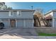 Townhome exterior with attached garages, private entrances and second floor deck access, showing functionality and style at 7945 York St # 2, Denver, CO 80229