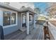 Charming home's porch featuring a welcoming entrance with natural wood details and neutral gray siding at 7945 York St # 2, Denver, CO 80229