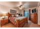 Serene main bedroom with a king-size bed, ceiling fan, and warm lighting, creating a comfortable retreat at 7945 York St # 2, Denver, CO 80229