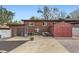 Backyard featuring a brick house, shed, patio and a combination of gravel, concrete and mulched areas at 8375 W 17Th W Ave, Lakewood, CO 80214