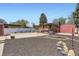 Spacious backyard featuring a covered patio, shed, and a combination of gravel and mulched areas at 8375 W 17Th W Ave, Lakewood, CO 80214