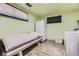 Basement laundry room with a tanning bed, washer, dryer, wood look floors, and painted walls at 8375 W 17Th W Ave, Lakewood, CO 80214