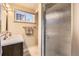 Bathroom featuring a vanity with granite countertop, brushed metal fixtures, and a glass shower enclosure at 8375 W 17Th W Ave, Lakewood, CO 80214