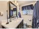 Bathroom featuring a granite vanity countertop, blue accents, and shower with textured glass door at 8375 W 17Th W Ave, Lakewood, CO 80214