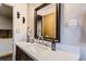 Bathroom featuring a vanity with granite countertop, large mirror, and brushed metal fixtures at 8375 W 17Th W Ave, Lakewood, CO 80214