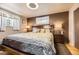 A cozy bedroom with a gray, gold, and white comforter set and dark-stained wood furnishings at 8375 W 17Th W Ave, Lakewood, CO 80214