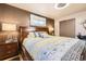Bedroom with a large wooden headboard, gray bedding, wood floors, and a sliding closet door at 8375 W 17Th W Ave, Lakewood, CO 80214
