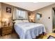 Bedroom with hardwood floors, neutral color scheme, large windows and two wooden nightstands at 8375 W 17Th W Ave, Lakewood, CO 80214