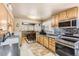 Modern kitchen boasts stainless steel appliances and a stylish tile backsplash at 8375 W 17Th W Ave, Lakewood, CO 80214