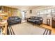 Inviting living room featuring hardwood floors, a large window, and comfortable leather sofas at 8375 W 17Th W Ave, Lakewood, CO 80214