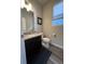 Modern powder room featuring a granite countertop and black cabinets at 2383 S Troy Ct, Aurora, CO 80014