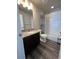 Full bathroom featuring a shower-tub combo and a dark vanity with a granite countertop at 2383 S Troy Ct, Aurora, CO 80014