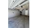 Spacious garage with overhead lighting, shelving, and concrete floors, ready for parking and storage solutions at 2383 S Troy Ct, Aurora, CO 80014
