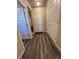 Inviting hallway featuring wood-style flooring and bright white paneled doors at 2383 S Troy Ct, Aurora, CO 80014