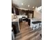 Modern kitchen with stainless steel appliances, dark cabinets, and granite countertops at 2383 S Troy Ct, Aurora, CO 80014