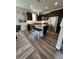 Open-concept kitchen featuring stainless steel appliances, dark cabinetry, and a granite-topped island with seating at 2383 S Troy Ct, Aurora, CO 80014