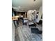 Open concept living area featuring a modern kitchen, living space, and staircase at 2383 S Troy Ct, Aurora, CO 80014