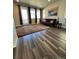 Bright living room with hardwood floors, large windows, and a modern sofa at 2383 S Troy Ct, Aurora, CO 80014