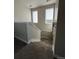 Carpeted staircase featuring neutral colors and natural light from windows in a modern home at 2383 S Troy Ct, Aurora, CO 80014