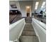 Carpeted staircase with railing that highlights the open living space at 2383 S Troy Ct, Aurora, CO 80014
