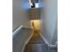 Carpeted stairway leading to a white door under recessed lighting at 2383 S Troy Ct, Aurora, CO 80014