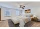 Bright main bedroom with a king-size bed and plantation shutters at 12883 Columbine Cir, Thornton, CO 80241