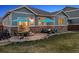 Beautiful backyard patio with fire pit, seating area, and blue umbrellas at 25148 E Lake Pl, Aurora, CO 80016