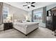 Comfortable bedroom boasts a tufted headboard, soft lighting, and neutral tones, creating a relaxing and inviting space at 25148 E Lake Pl, Aurora, CO 80016