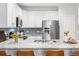 Modern kitchen showcasing granite countertops, stainless steel appliances, and bar seating at 25148 E Lake Pl, Aurora, CO 80016