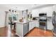 Modern kitchen with stainless steel appliances, granite countertops, and a breakfast bar at 25148 E Lake Pl, Aurora, CO 80016