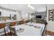 Open-concept kitchen and dining area with modern appliances, bar seating, and dining table at 25148 E Lake Pl, Aurora, CO 80016