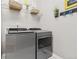 Efficient laundry room showcases modern appliances, ample shelving, and clean design, making chores a breeze at 25148 E Lake Pl, Aurora, CO 80016