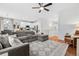 Open-concept living area with a comfortable sectional, hardwood floors, and access to the kitchen at 25148 E Lake Pl, Aurora, CO 80016