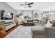 Spacious living room with hardwood floors, a large sectional sofa, and stylish decor at 25148 E Lake Pl, Aurora, CO 80016