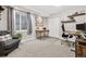 Bright office space with a comfortable seating area, a window, and a stylish desk, creating a productive workspace at 25148 E Lake Pl, Aurora, CO 80016