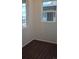Bright bedroom featuring modern windows, light-colored walls, and dark wood floors at 394 Grey Rock St, Brighton, CO 80601